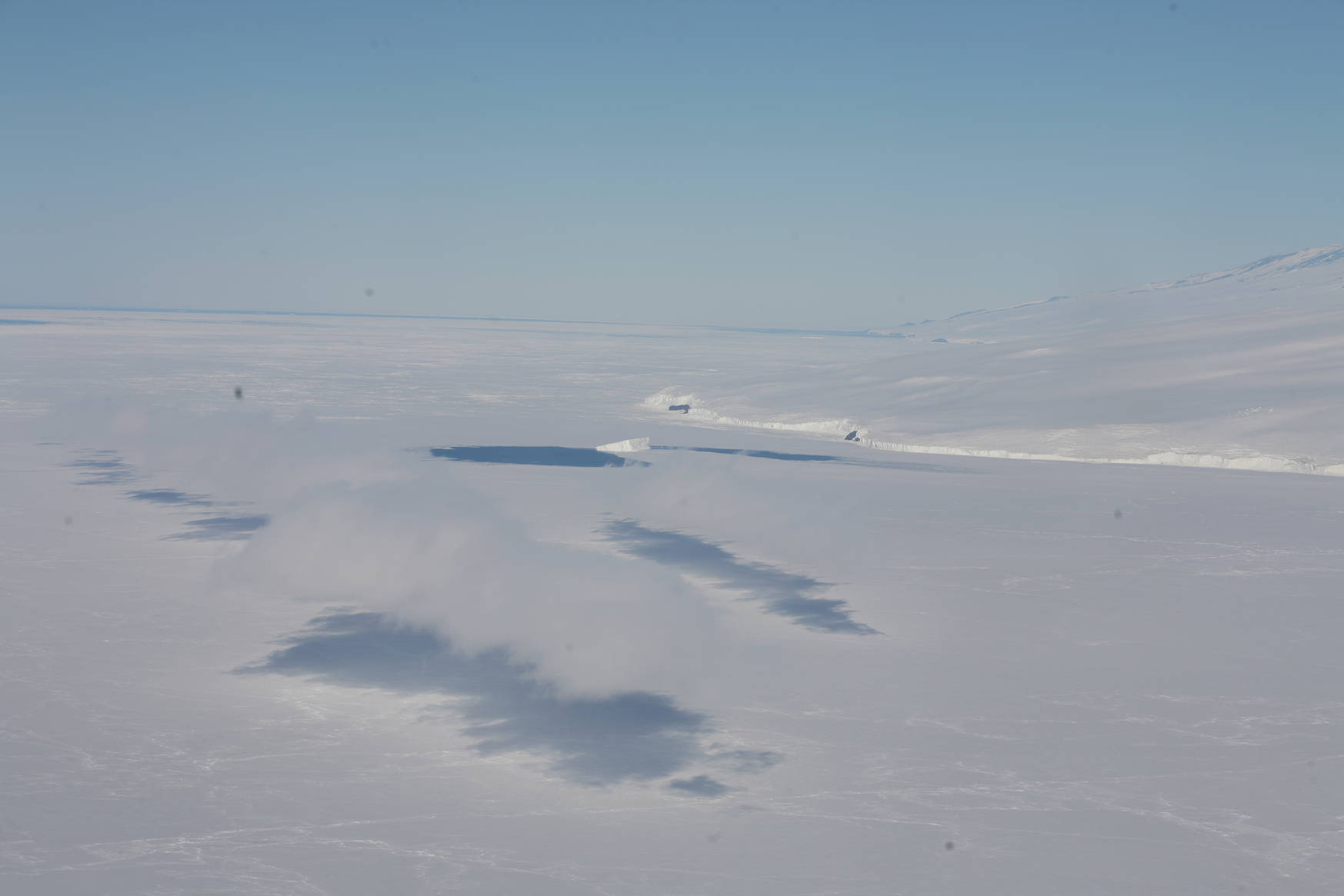 Low-hanging clouds above the Antarctic coast.