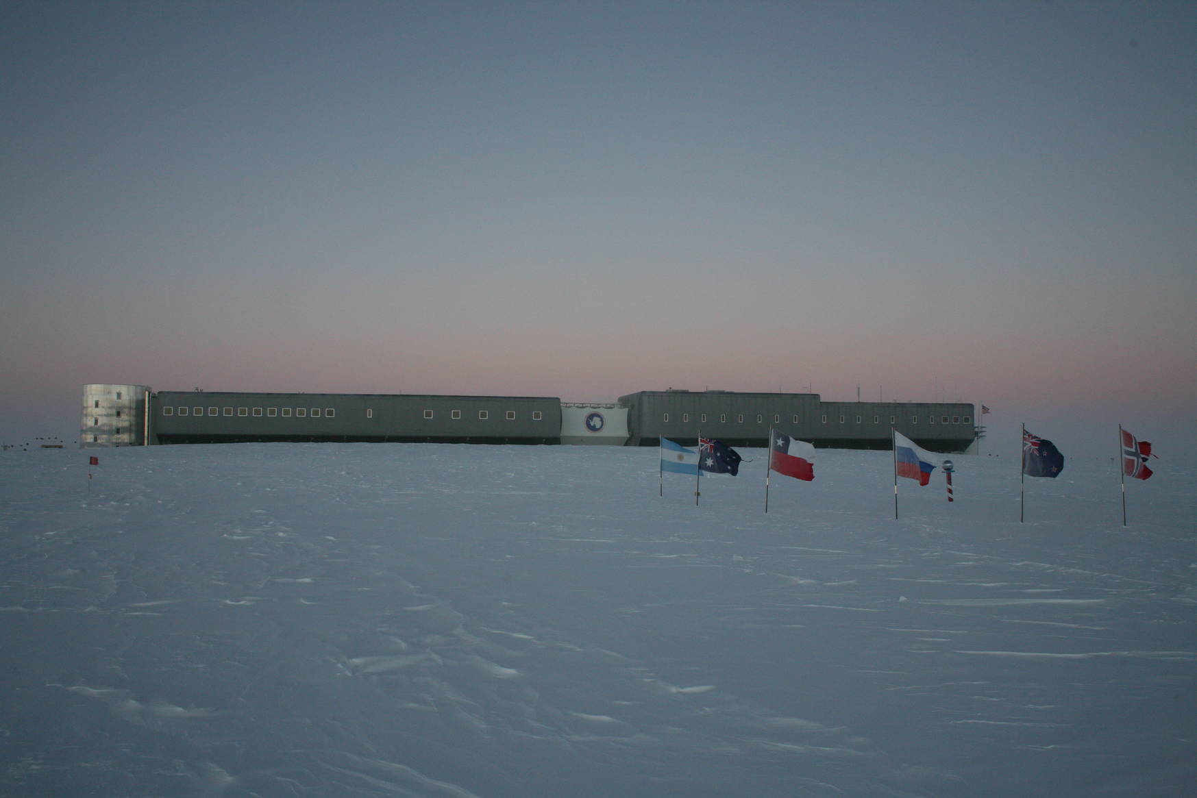 The ceremonial south pole and the south pole station during sunset (opposite of the sun).