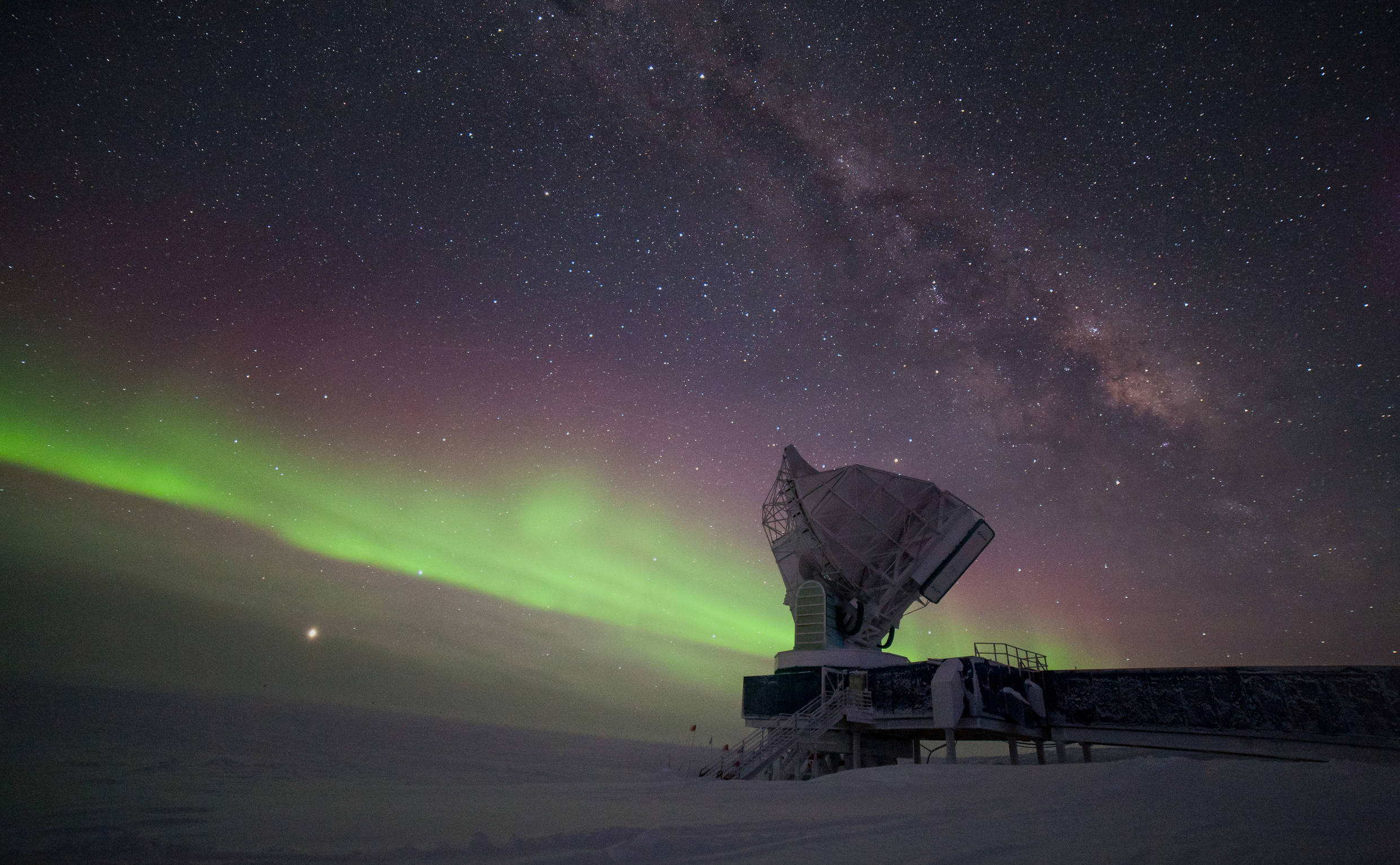 Taken in -60°C, this picture shows the South Pole Telescope illuminated by the Milky Way and some of the first aurora australis of the winter season 2017. Jupiter is brightly visible on the lower left, Saturn is to the right of the telescope dish. 