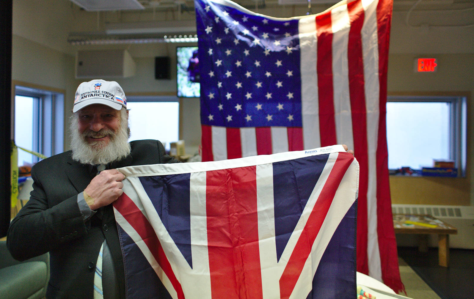 Rick happily presenting the UK flag that was flown at the ceremonial pole throughout the winter. Behind him the station flag.